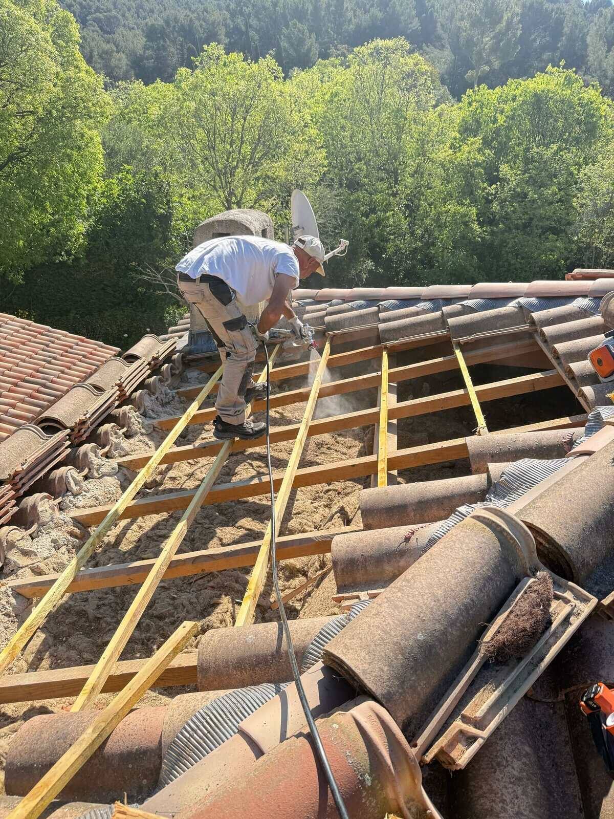 Charpentiers traitant une charpente en bois dans le Var